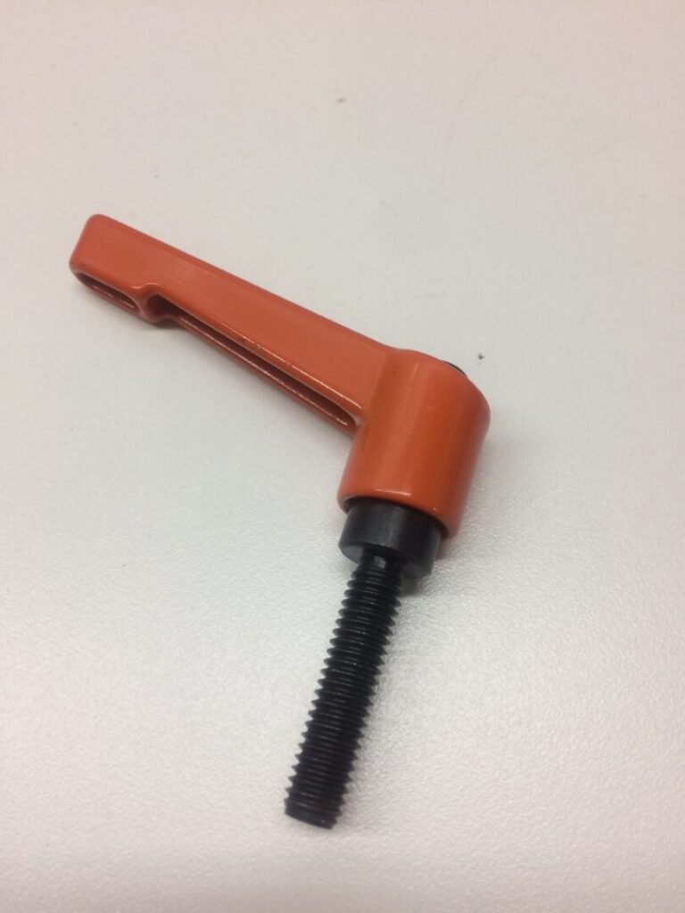 Spring-loaded clamp for industrial and electronic applications, orange and black color, used for securing components.