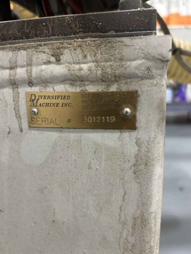 Serial number plate on industrial equipment for machinery identification.